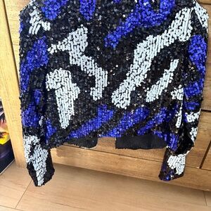 This is a sequin bomber jacket by manufacturer a period peach